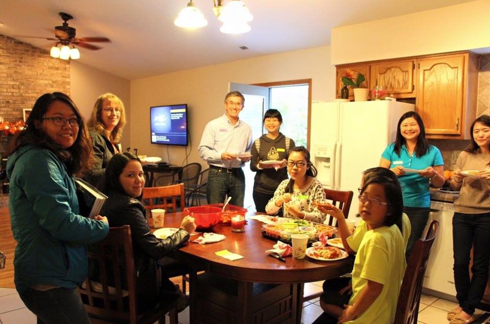 Students sitting in kitchen of one of our IFP Hosts