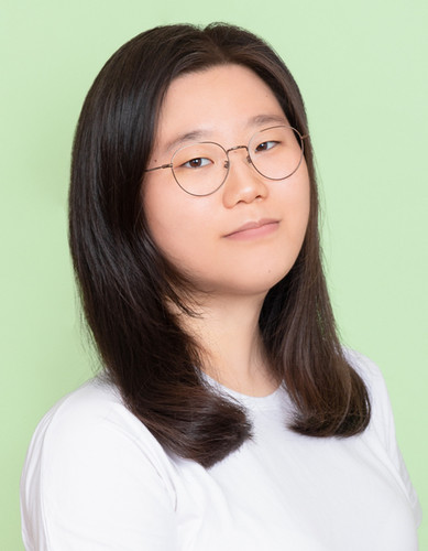 Student wearing a white shirt with a green background