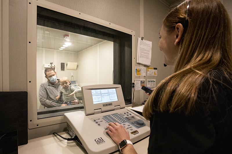 Purdue graduate student Natalie Seidl tests a subject’s hearing in a sound-attenuating booth