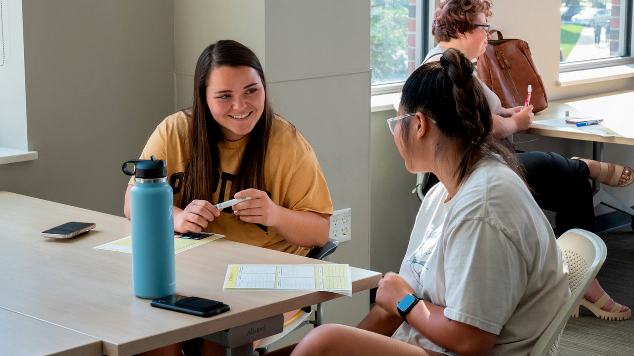 FSCL students talking at table
