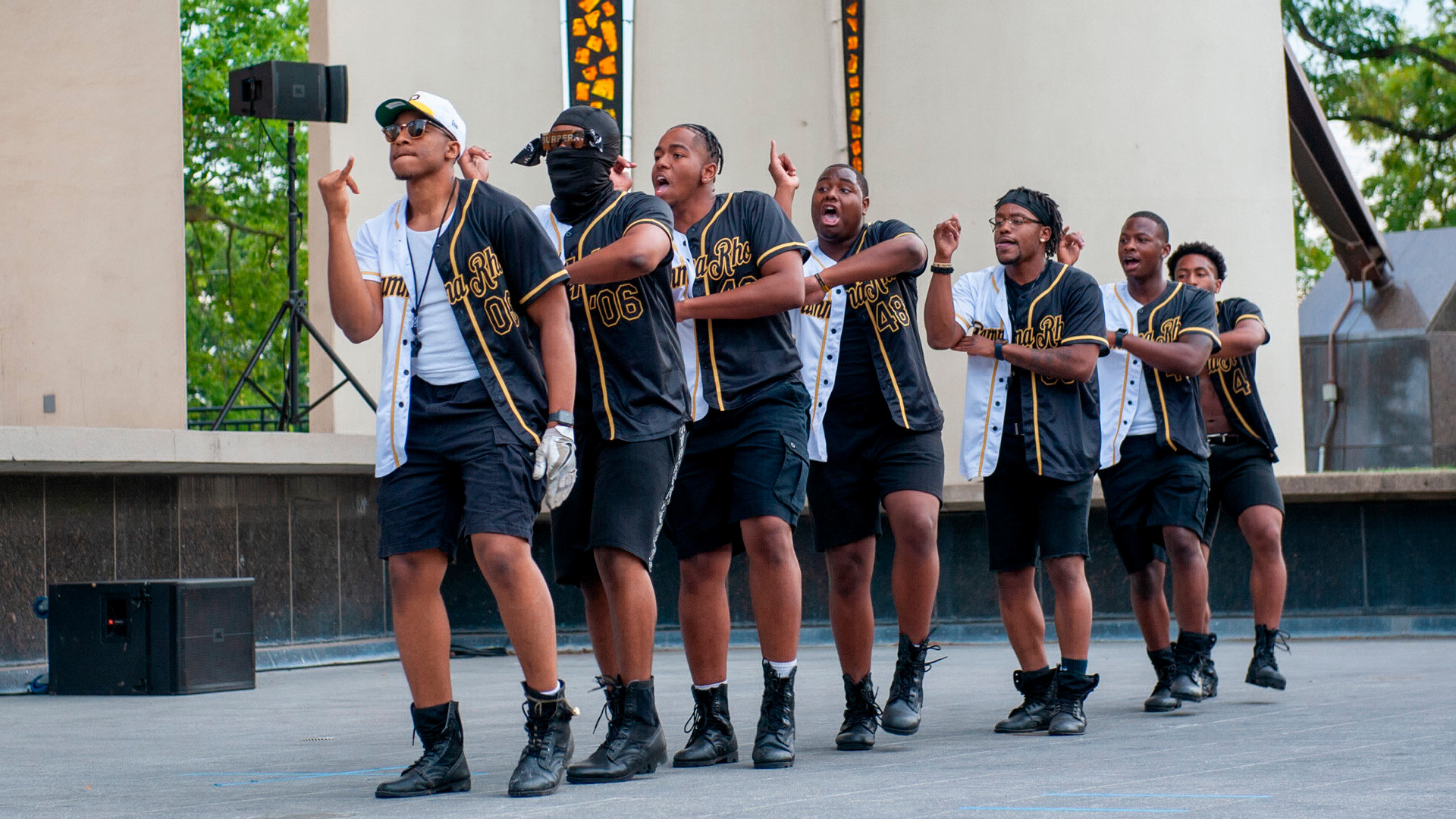 Students doing a dance on stage at Slayter Hill while participating in the NPHC Yard show. 