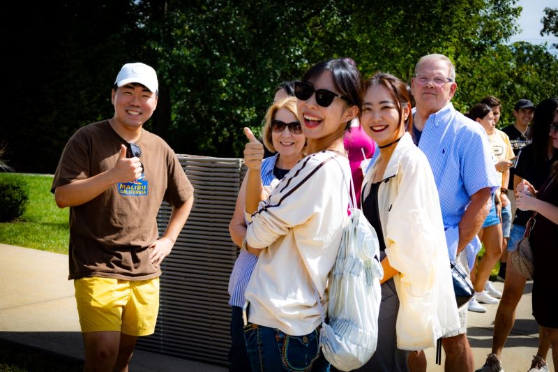 Students and hosts enjoying time together at a cookout.