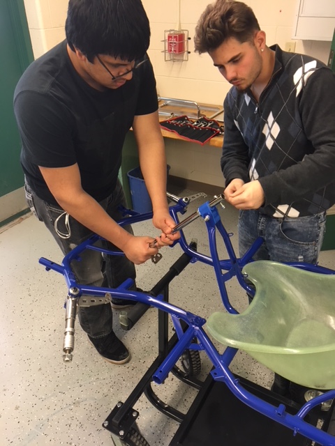 Students constructing a metal apparatus