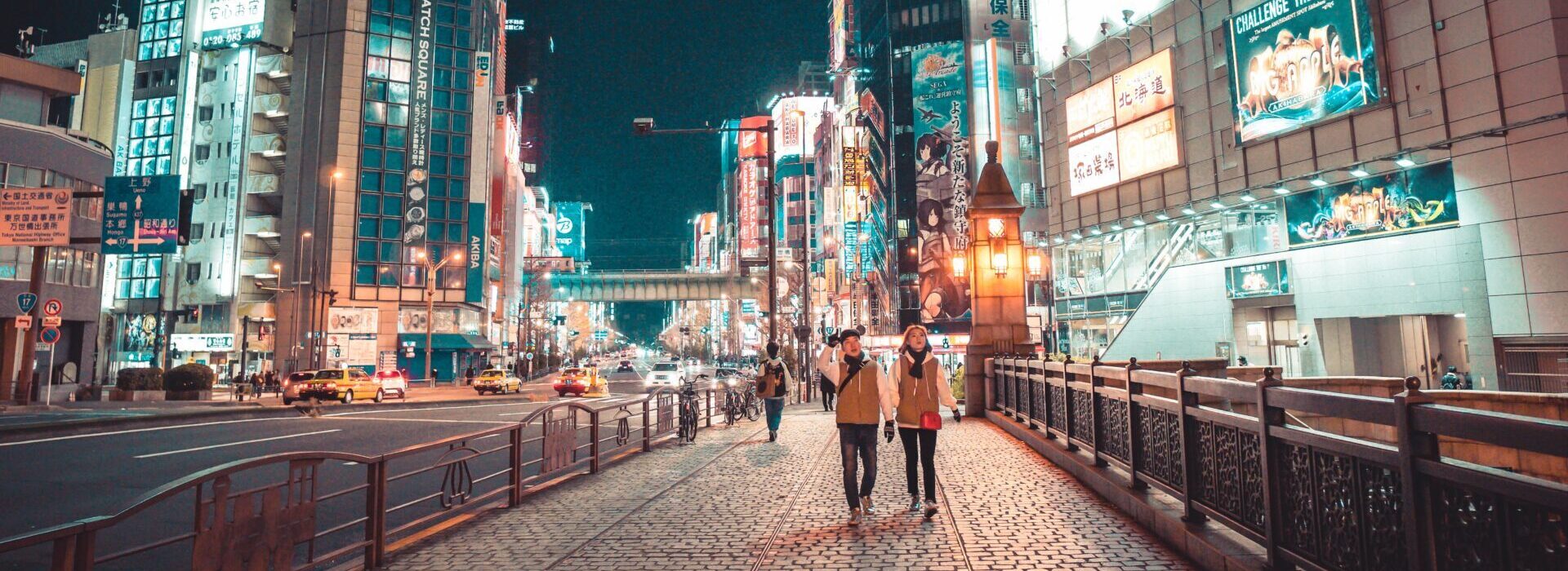Couple walking down city sidewalk