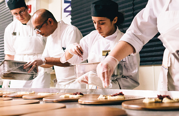 Chef Ambarish Lulay and students plate dinner for “At the Illusionist’s Table.”