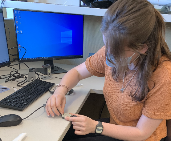 In A.J. Schwichtenberg’s lab, students learn to use actigraphy, a small wrist worn device that measure activity which can be converted into rough estimates of sleep and wakefulness. Here a student is wearing an actigraph and is plugging another one in to download the data.