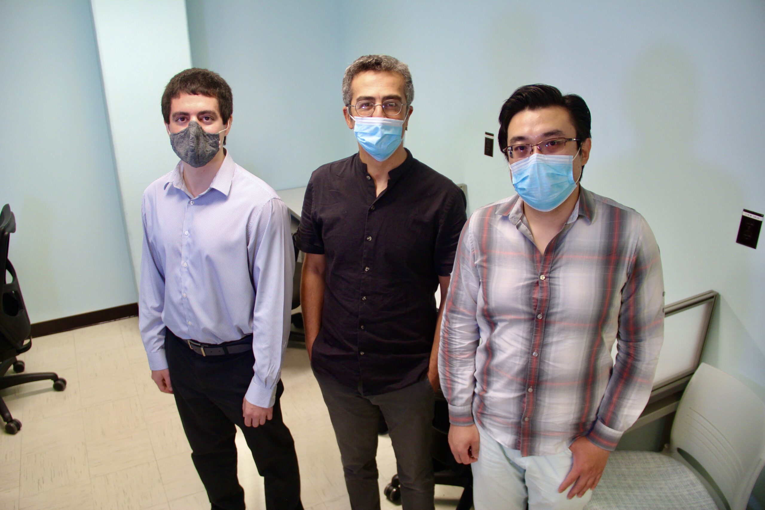 Uzay Emir stands with his doctoral students Xin Shen and Nicholas Farley