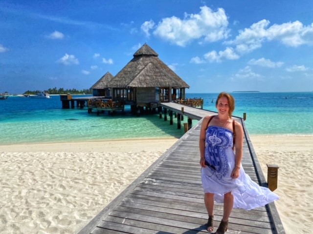 Liz Hoover stands outside of her room during a recent stay in the Maldives