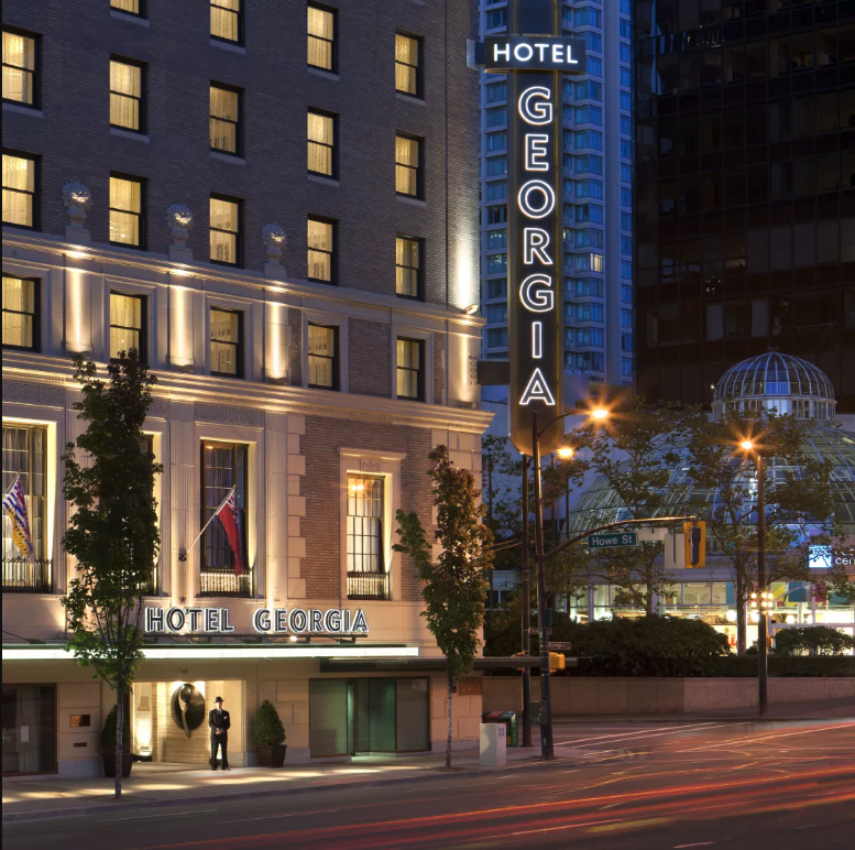 An exterior shot of the Rosewood Hotel Georgia at night.