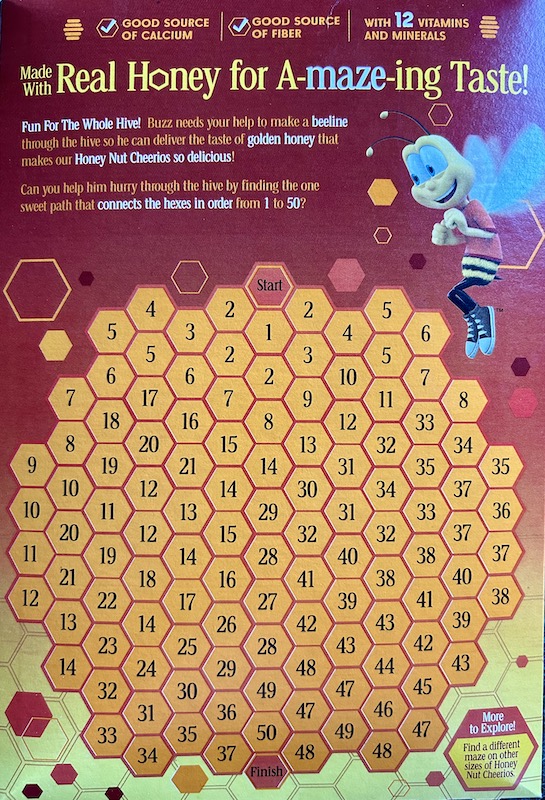 The back of a Honey Nut Cheerios box reveals a math activity.