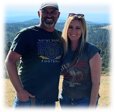 Kristina Cooley and husband with mountains behind them