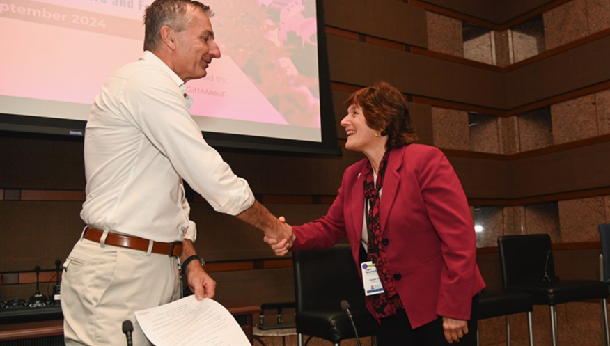 Karen Plaut, Purdue executive vice president for research [right], shakes hands with Robert Reiter, Bayer head of crop science research and development, after signing an agreement Sept. 19, 2024, in St. Louis creating the Coalition for Sustainable and Regenerative Agriculture. (Photo courtesy of Bayer)