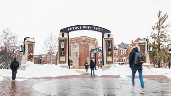 Students walking toward the Purdue Memorial Union during the winter.