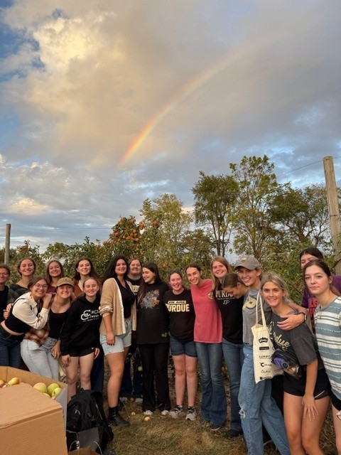 A group of women from the learning community at an apple picking event. 