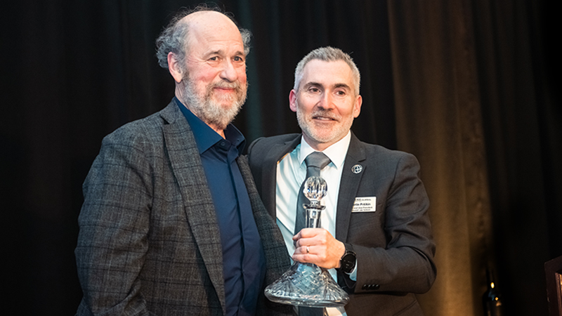 Steve Bracci, at left, receives the Lifetime Achievement in Bar Exam Support Award from Martin Pritikin, dean of the Concord Law School at Purdue Global, on Saturday (Feb. 25) during Concord Law School’s 25th anniversary celebration in Anaheim. Bracci serves as an associate dean and professor at Concord Law School. (Purdue Global photo/Jon Garcia)