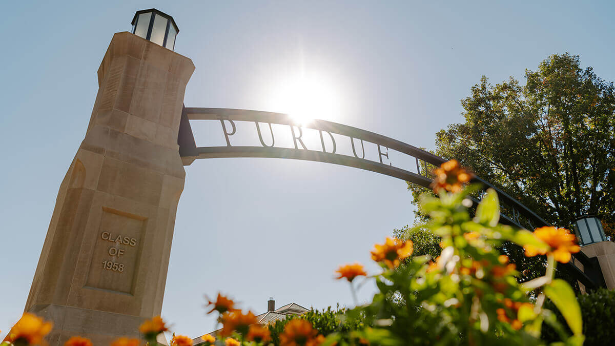 A view of the Purdue Arch from the flowers.