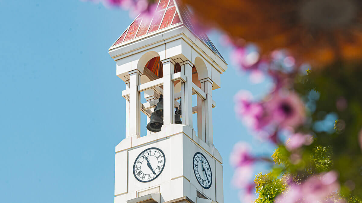 The Purdue Bell Tower and spring flowers.