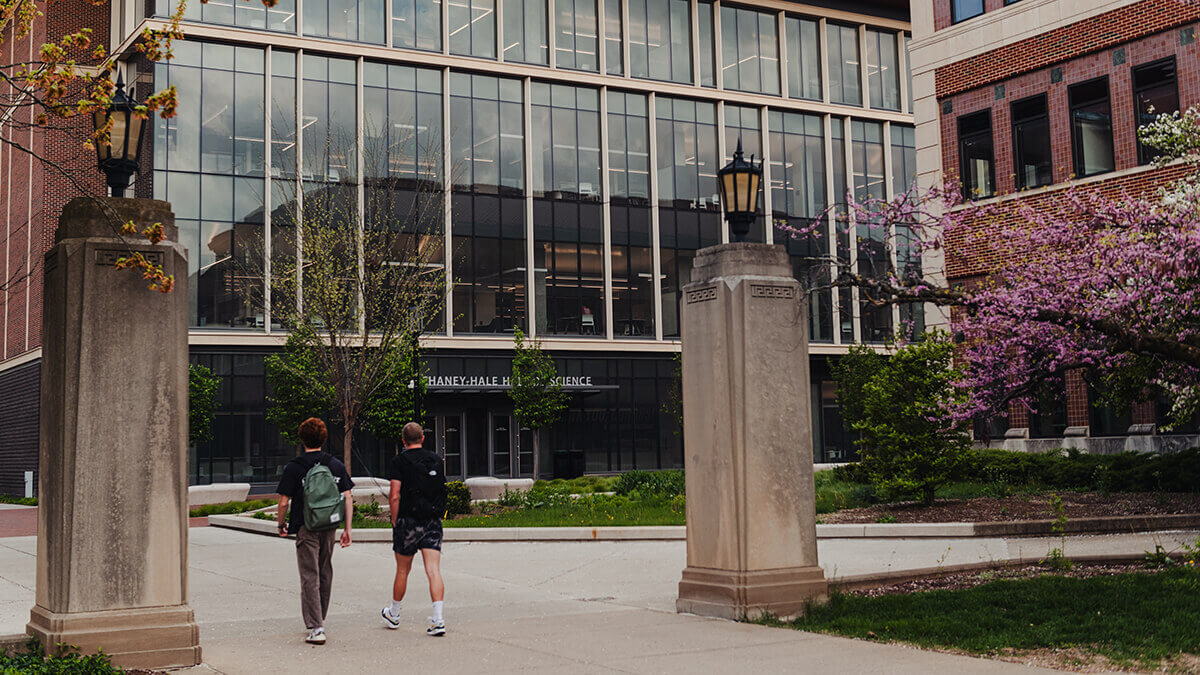 A Purdue building and students walking