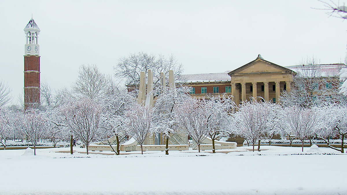 Trees and an academic building on Purdue University during the winter season.