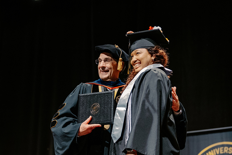 Chancellor Frank Dooley and graduating student