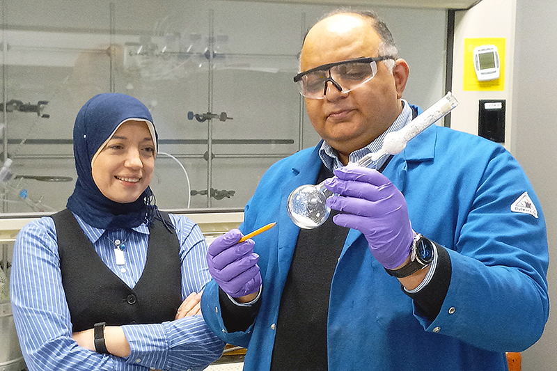 Two team members of Akanocure Pharmaceuticals in a lab.