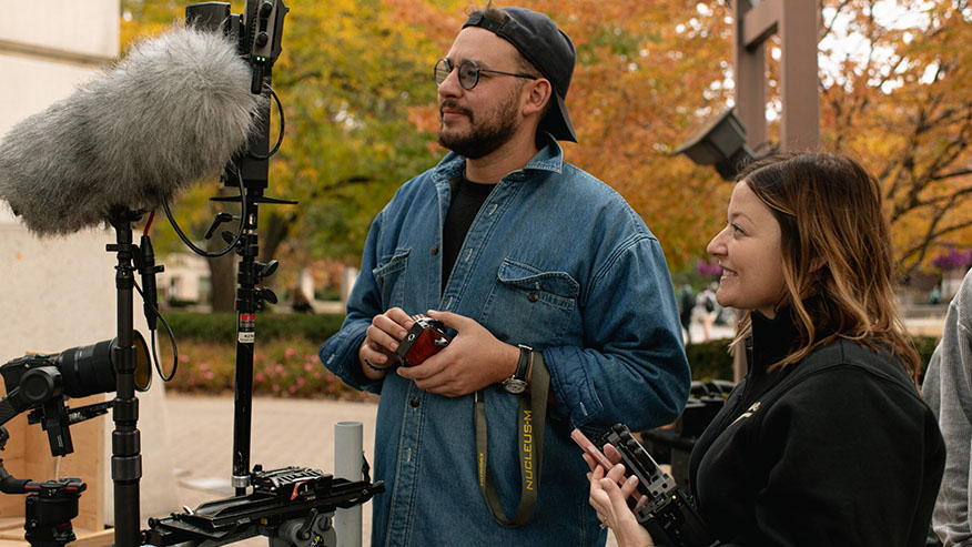 Two filmmakers watch a screen while cameras film “Boiler to Mars.”