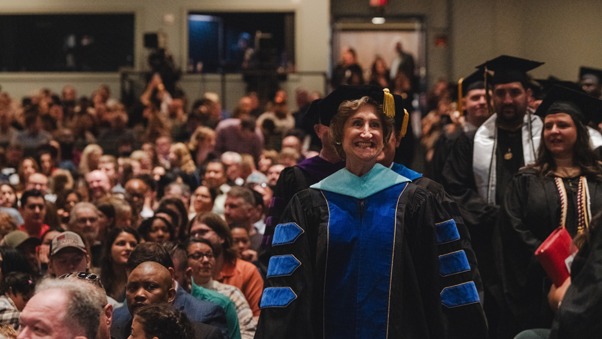 A woman leads a commencement ceremony