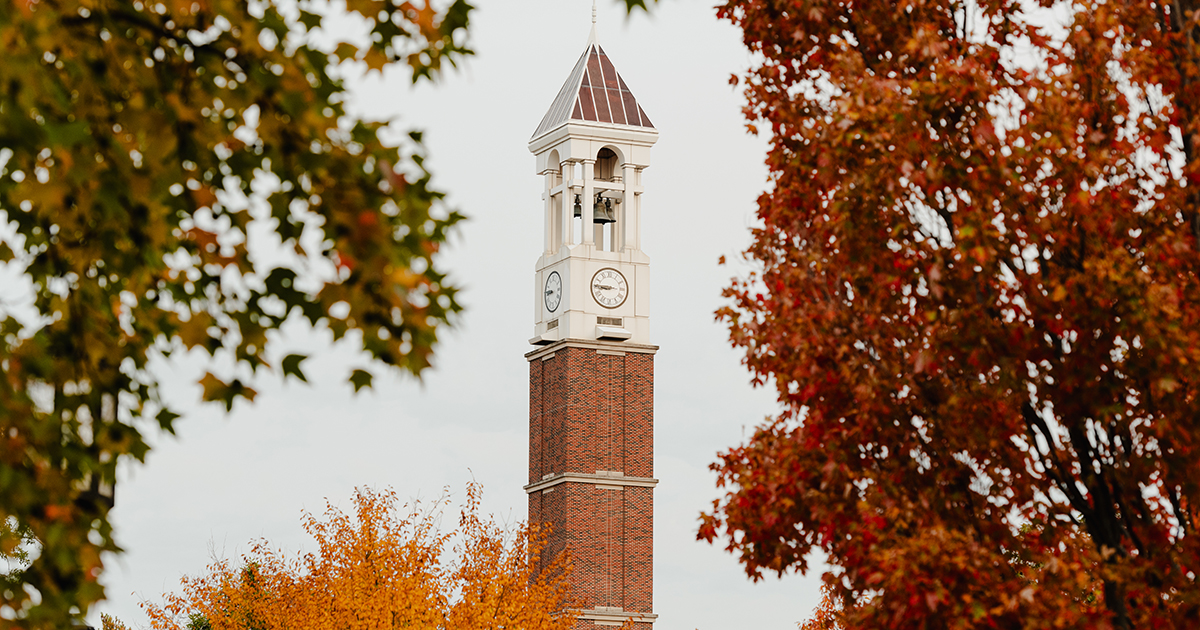 Purdue University bell tower with fall leaves around it