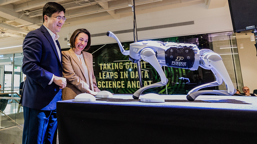 Purdue University President Moon Chan and Frederick L. Hovde Dean of Science Lucy Flesch celebrate with RoboDog.