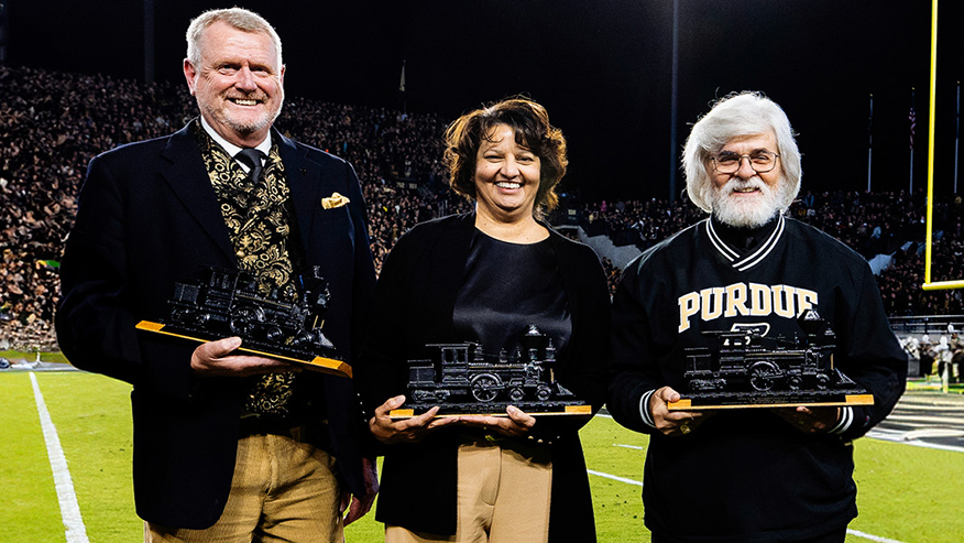 Anthony Cawdron, Renee Thomas and Frank Robert Sabol holding Special Boilermaker Awards