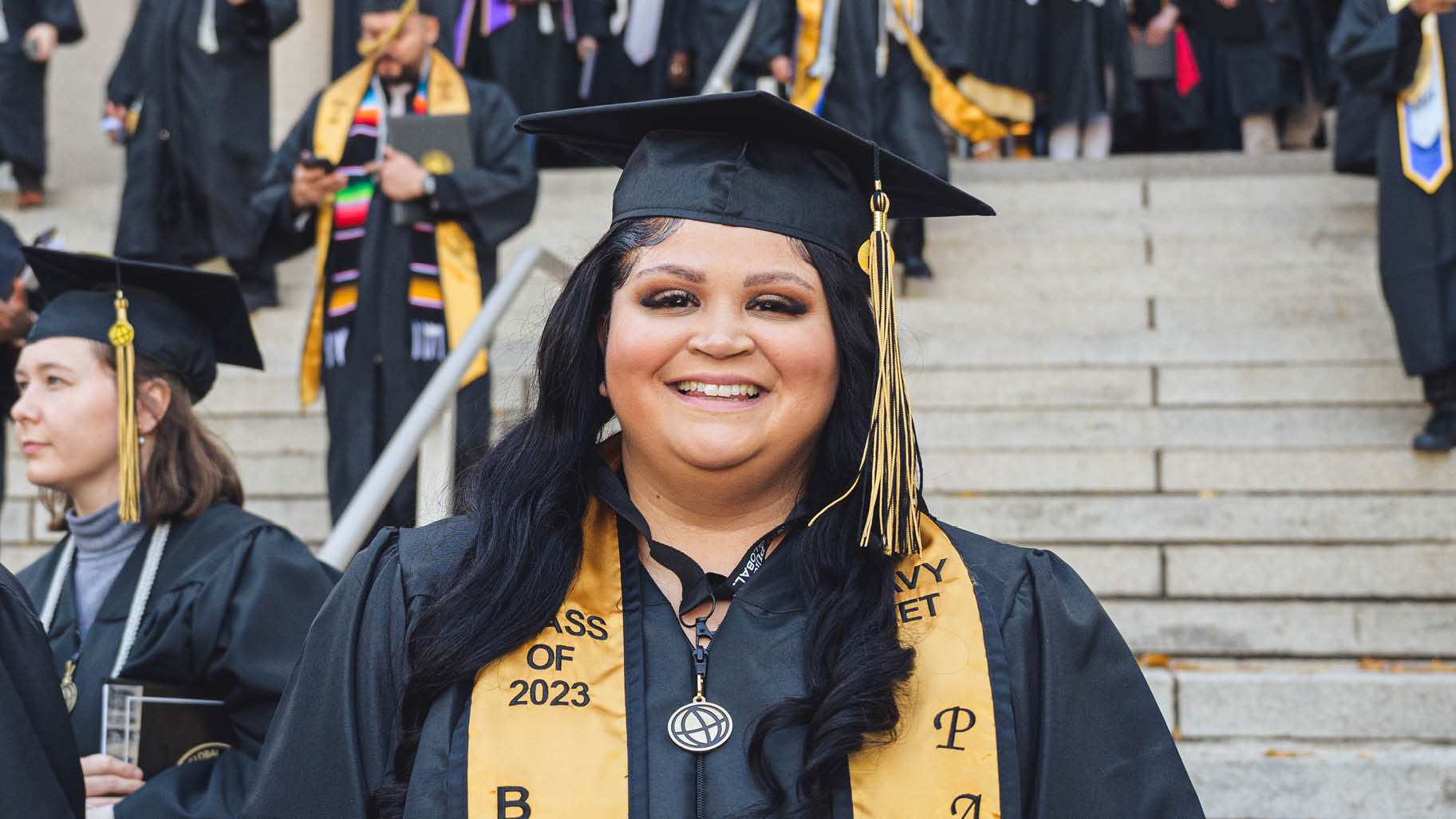 Military veteran woman in graduation cap and gown.