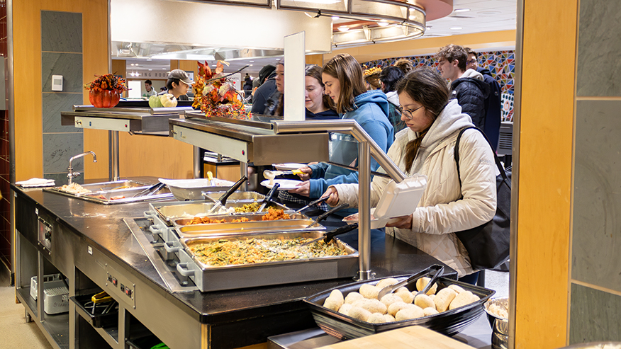 Students serve themselves food 