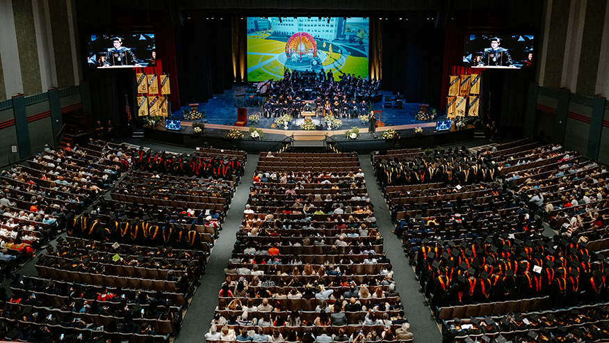 A wide-angle shot showing Purdue President Mung Chiang addressing graduating students in Elliott Hall of Music