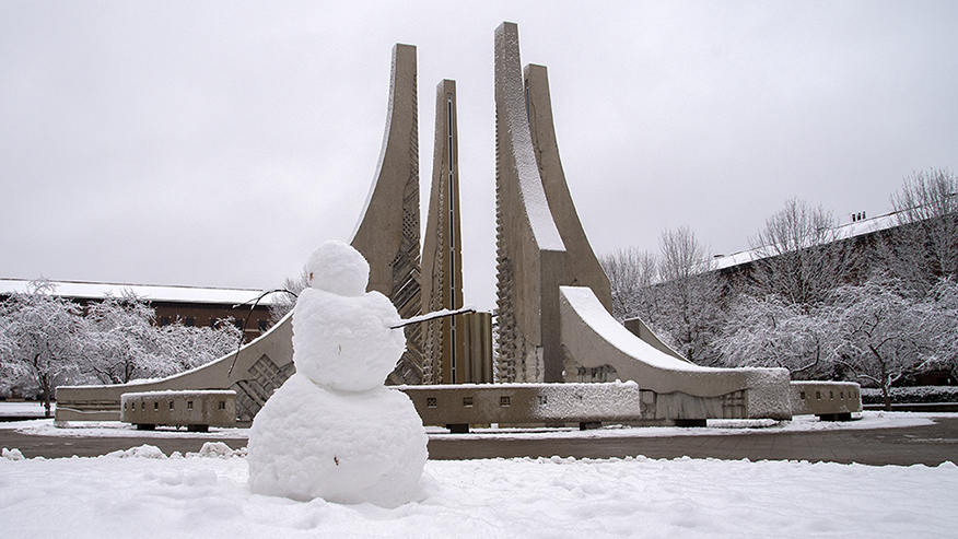 A snowman near the fountain on the Purdue Mall in winter