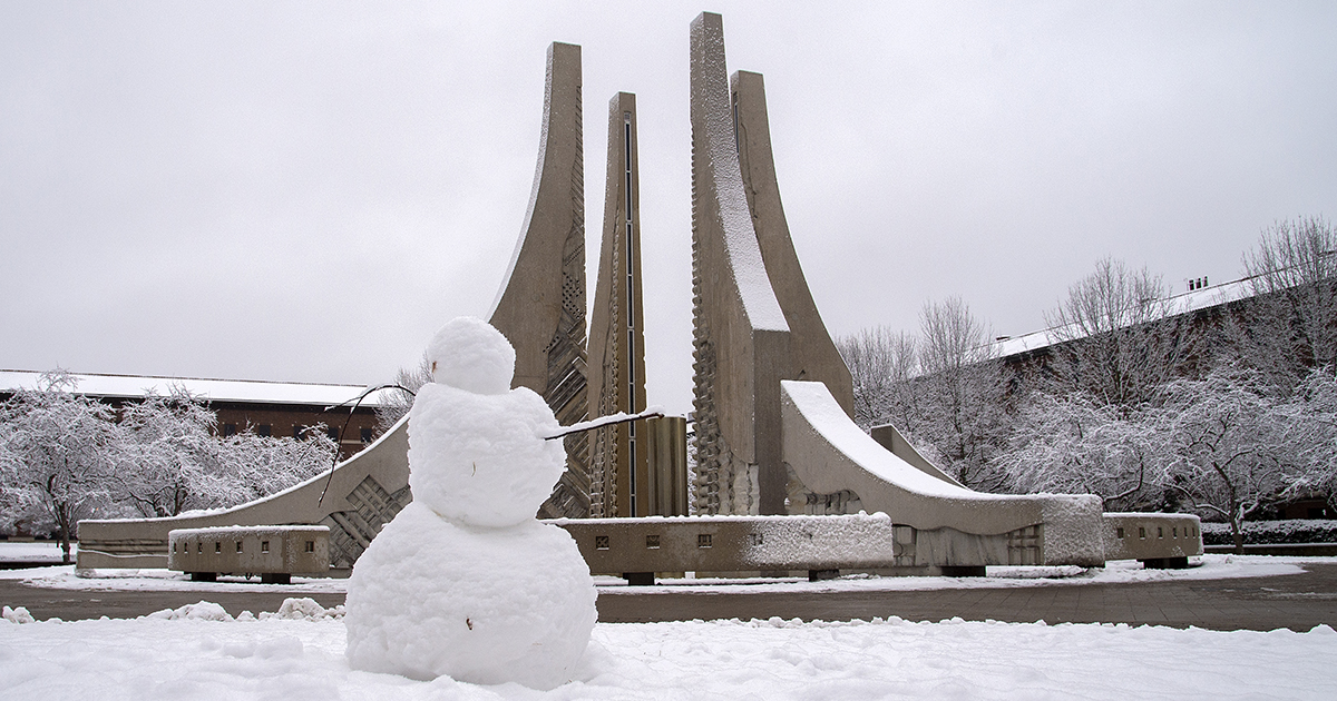 A snowman near the fountain on the Purdue Mall in winter