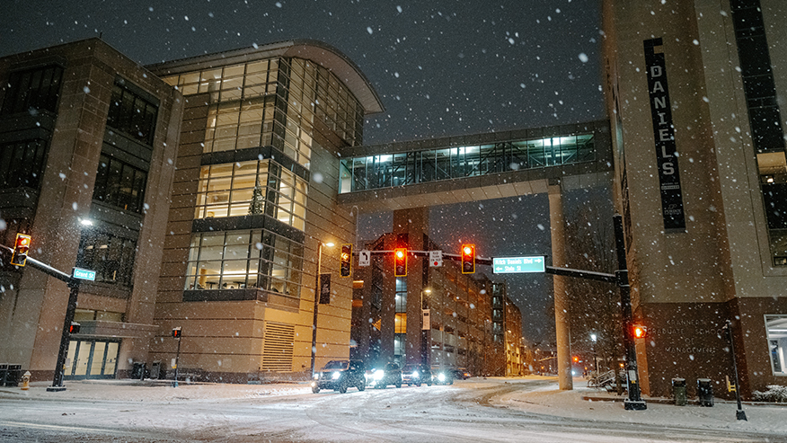 Snow falls after dark at the intersection of Mitch Daniels Boulevard and Grant Street.