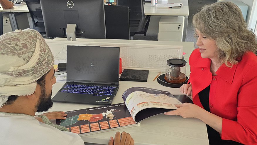 Genell Ebbini and Saeed Al-Shidhani at a workstation.