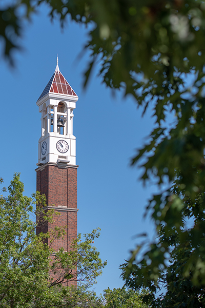 The Purdue Belltower visible through trees