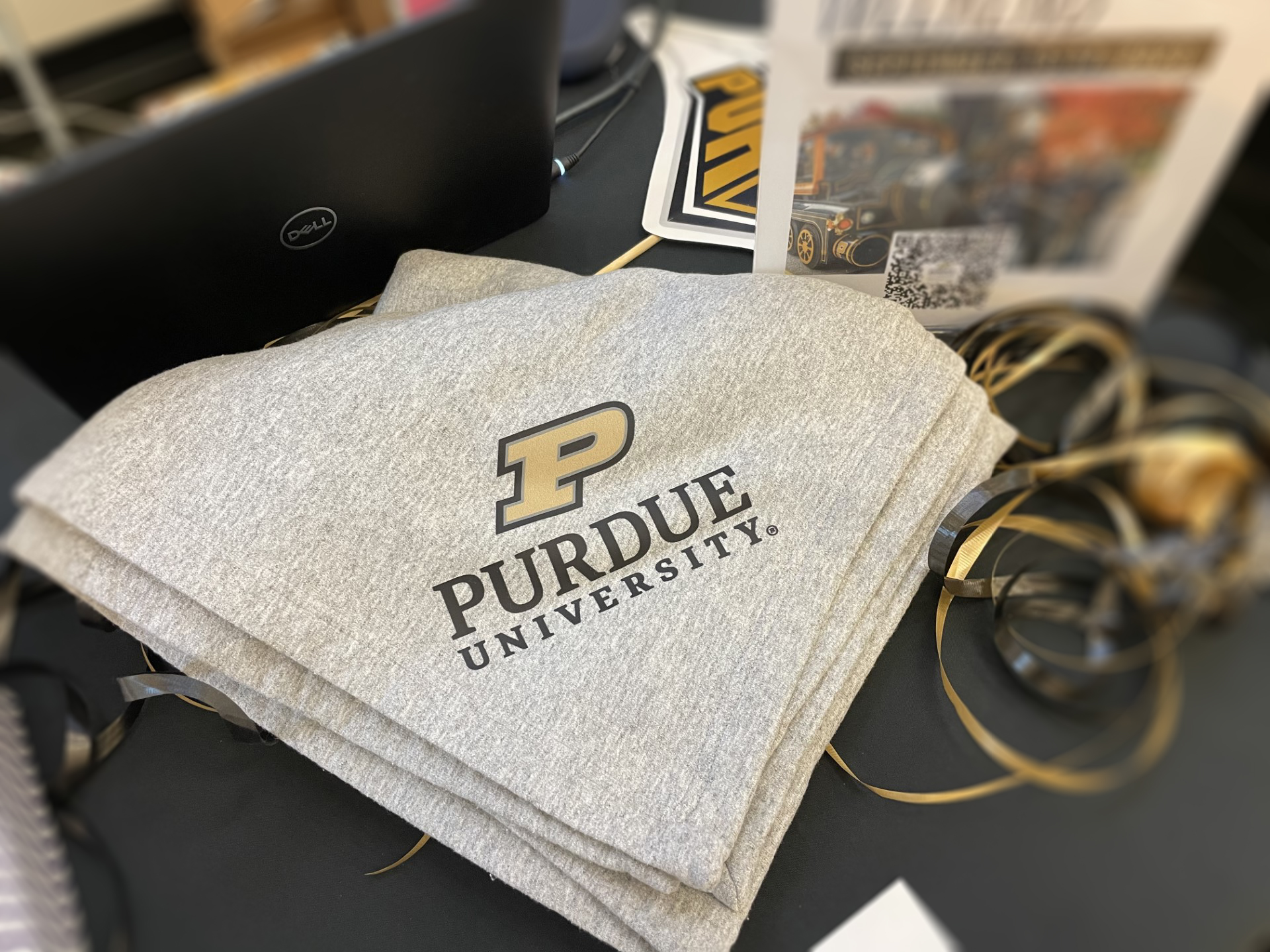 Grey sweatshirt blanket with motion P logo and Purdue University screen printed