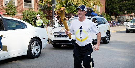 president Mitch Daniels running with the bicentennial torch