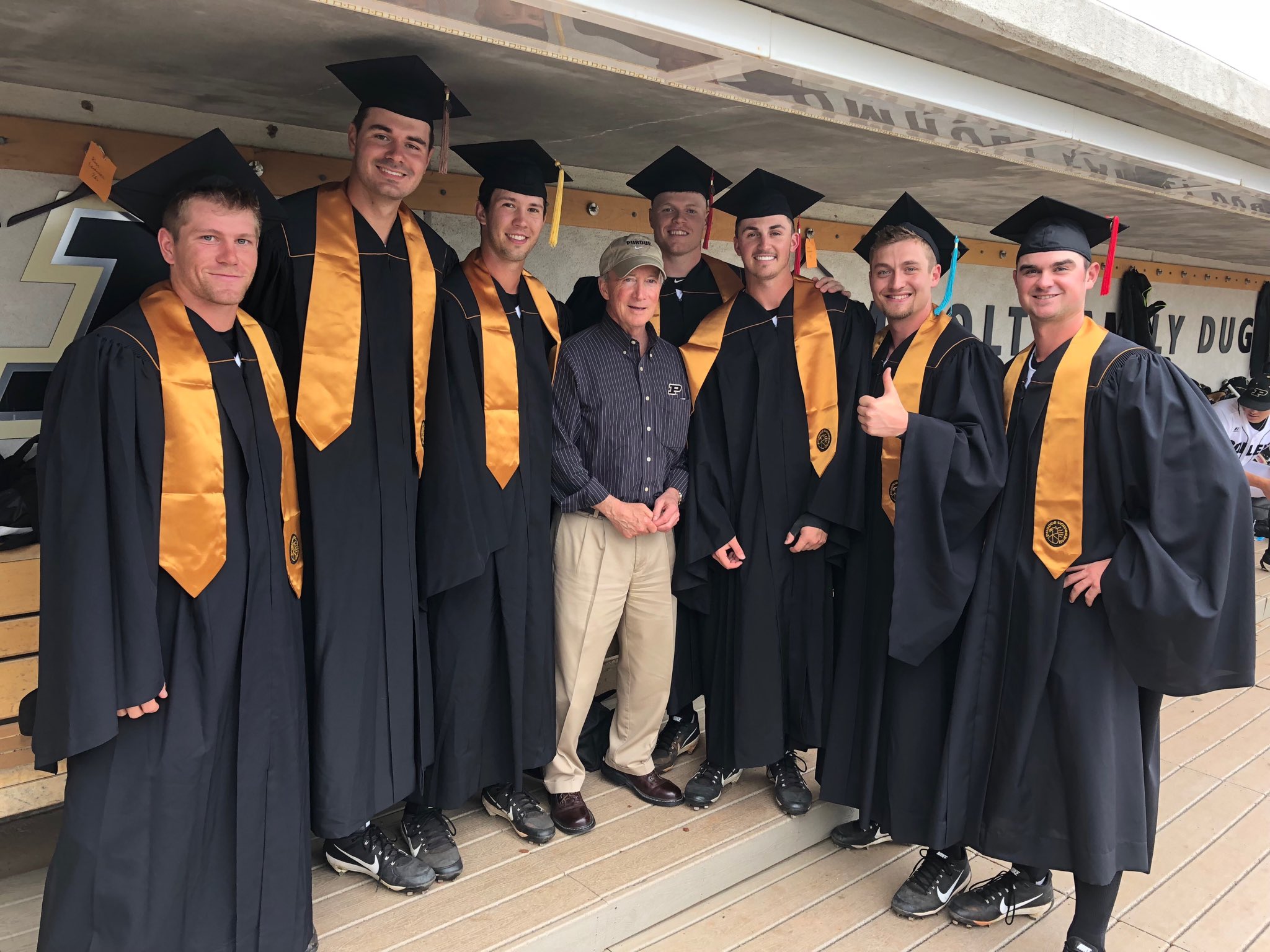 President Daniels in the dugout with seven Purdue Baseball graduates