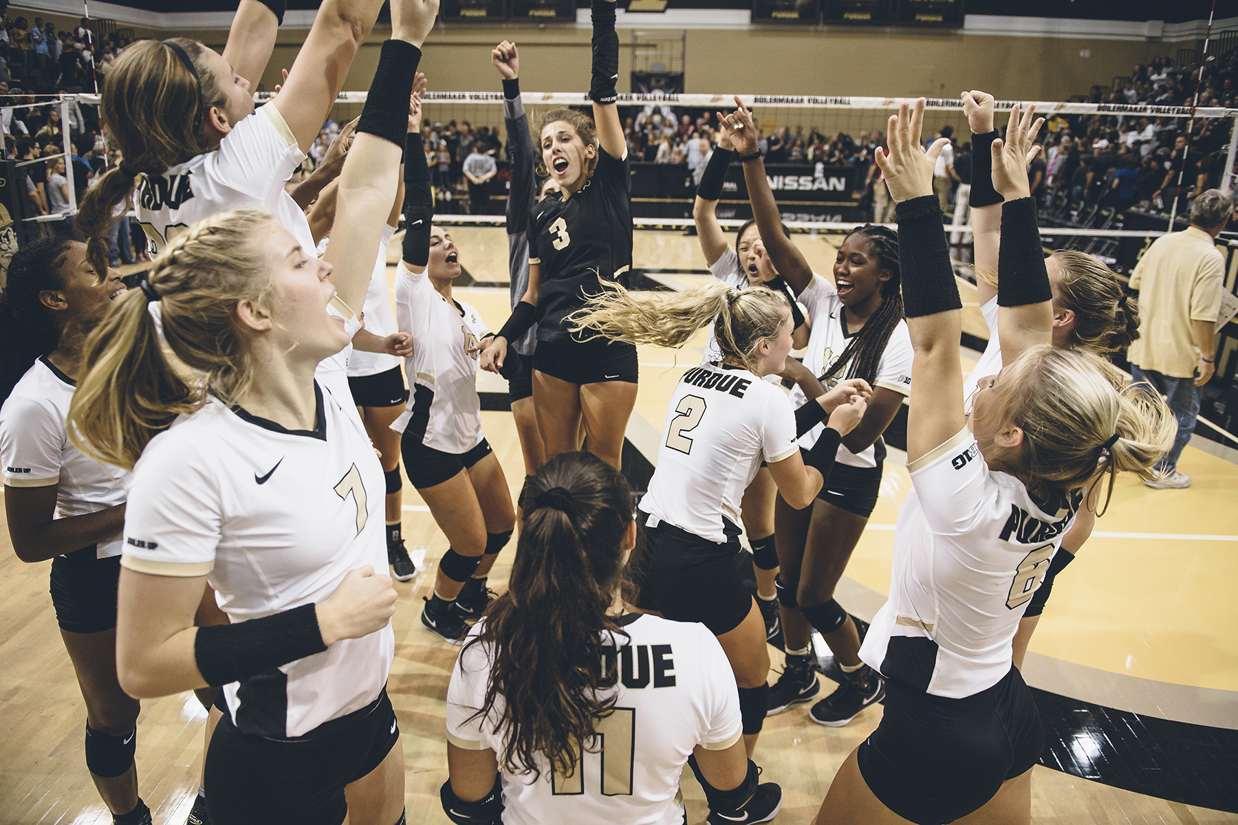Purdue women's volleyball team celebrates on the court