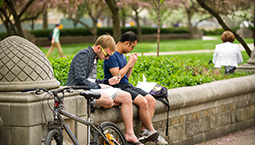 two students reading on campus