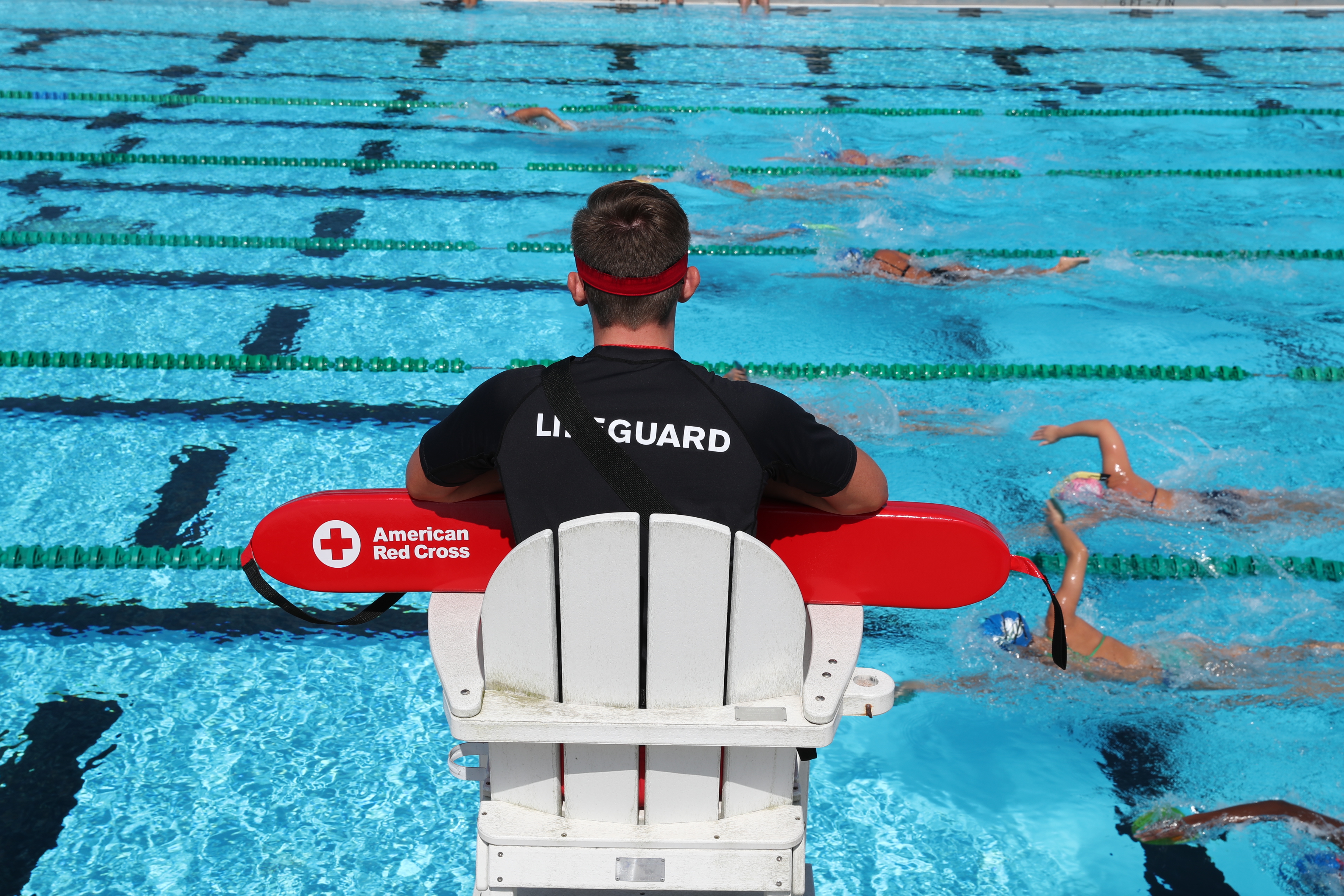 Lifeguard surveilling swimmers in lap lanes