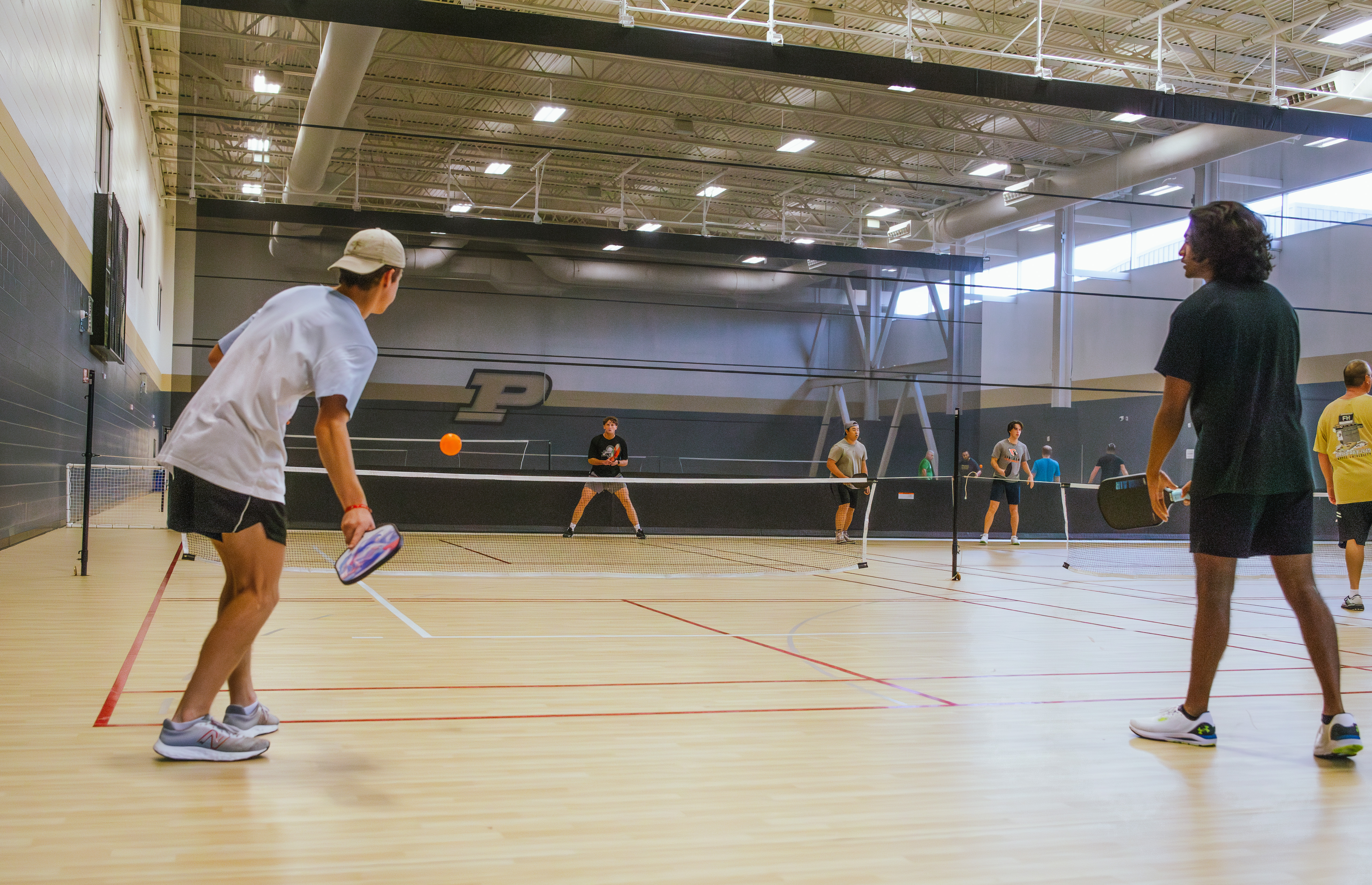Students playing pickleball in RecWell's MAC Gym