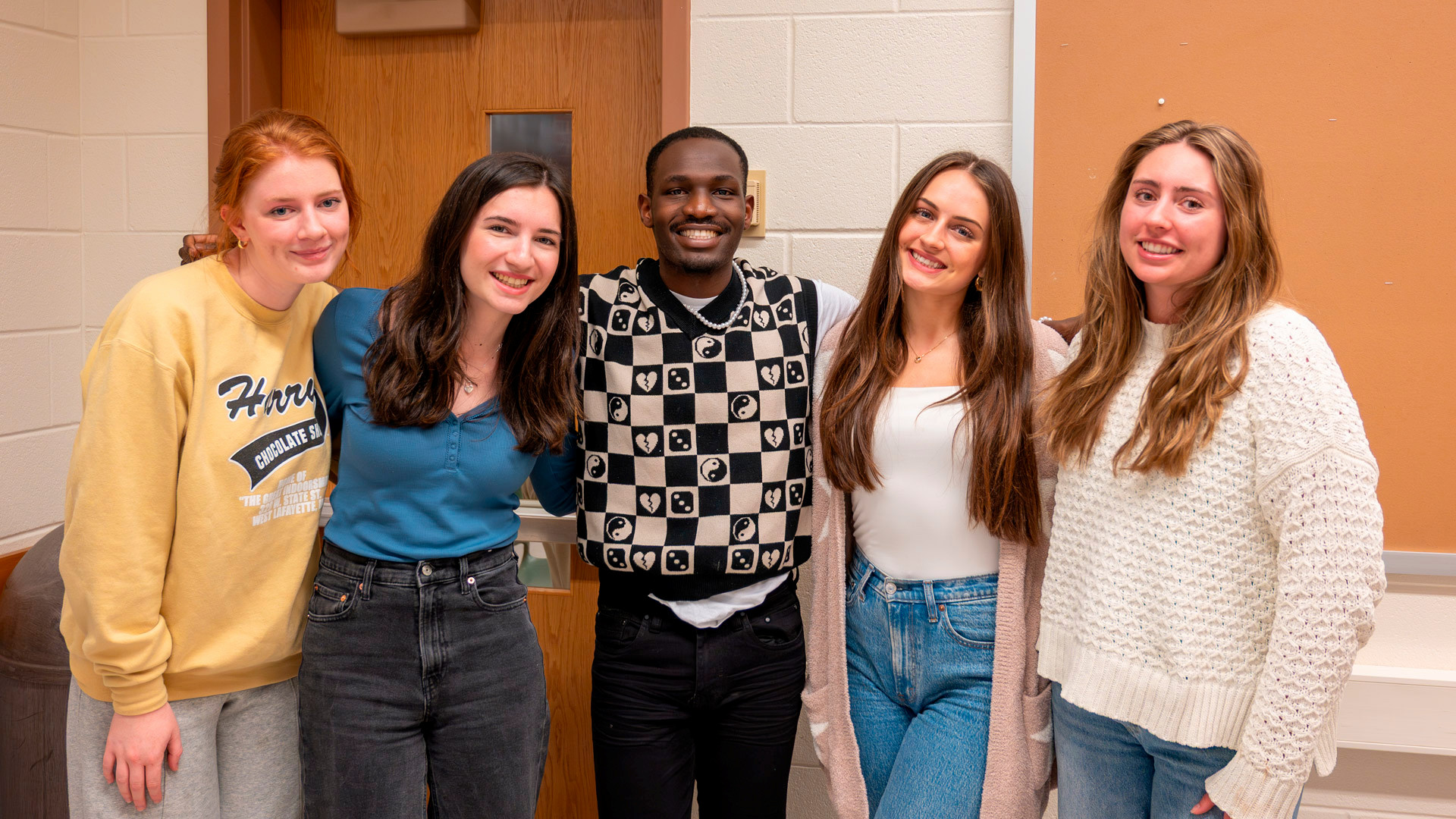Boiler Bakers student organization group photo of four students smiling at the camera, taken in the spring of 2025