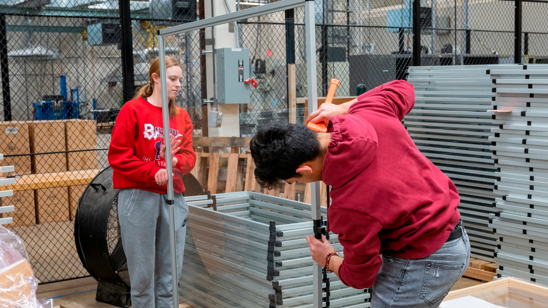 EPICS students re-using plexiglass from Covid for another project.