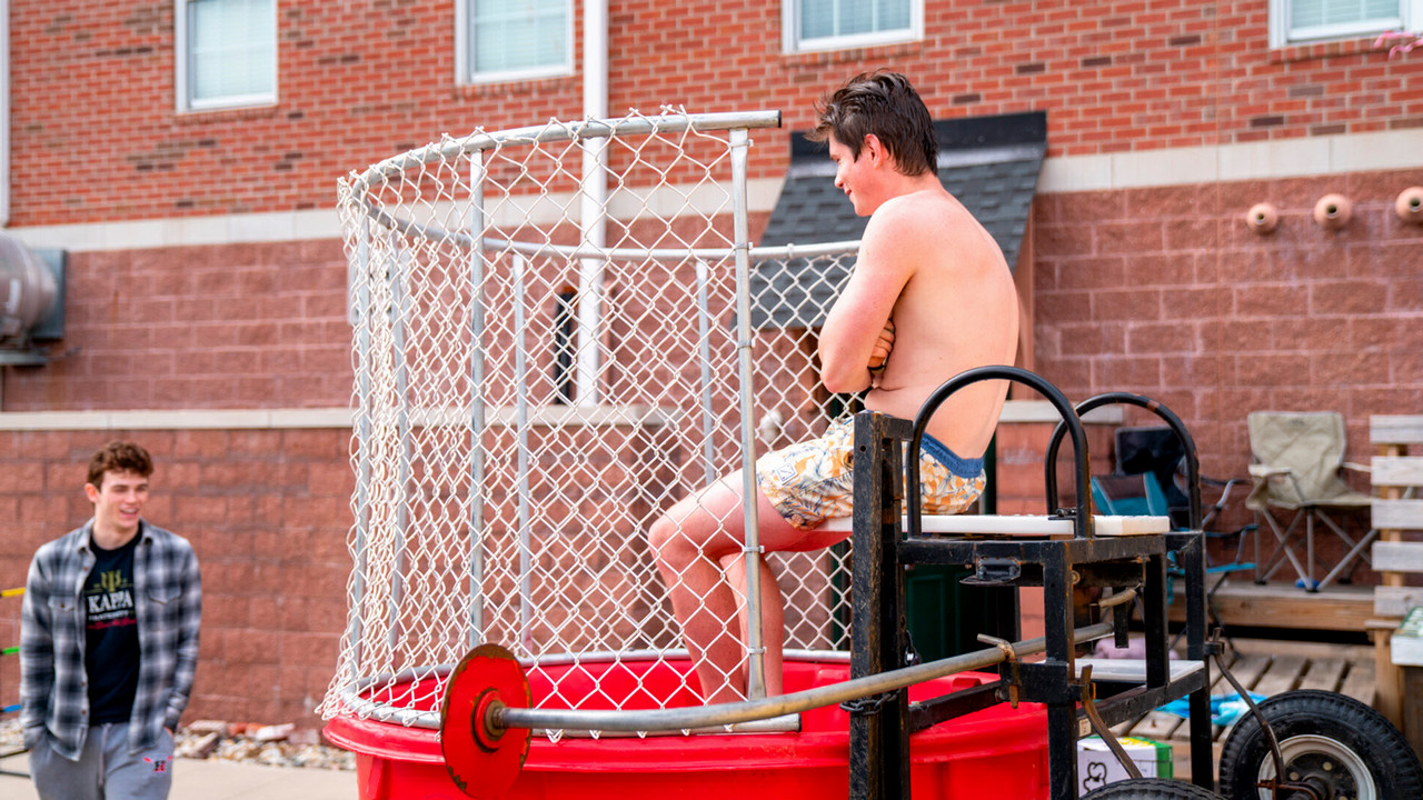 Phi Kappa Psi Fundraising Event with a student in the dunk tank. 