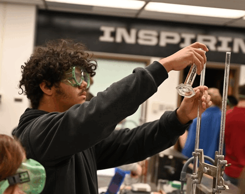 Student filling a burette while completing a buffers lab at Purdue University.