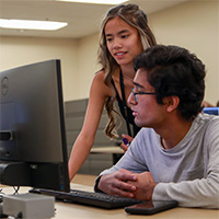 two students looking at a monitor